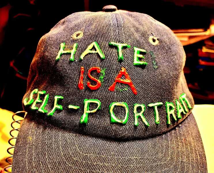 Ball cap inscribed with "hate is a self portrait", a message against Christian Nationalism. 